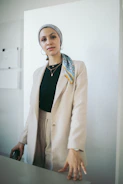 Close-up of a plus-size model in a chic, tailored blazer with bold accessories