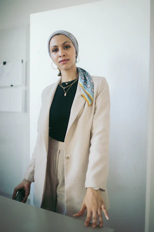 Model walking confidently in a minimalist, elegant office dress with subtle accessories