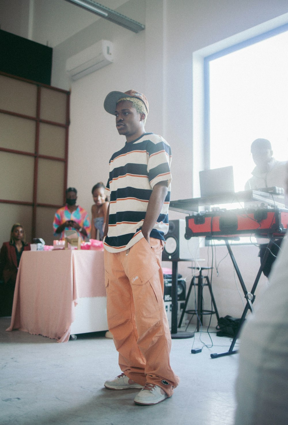 a man standing in front of a keyboard in a room