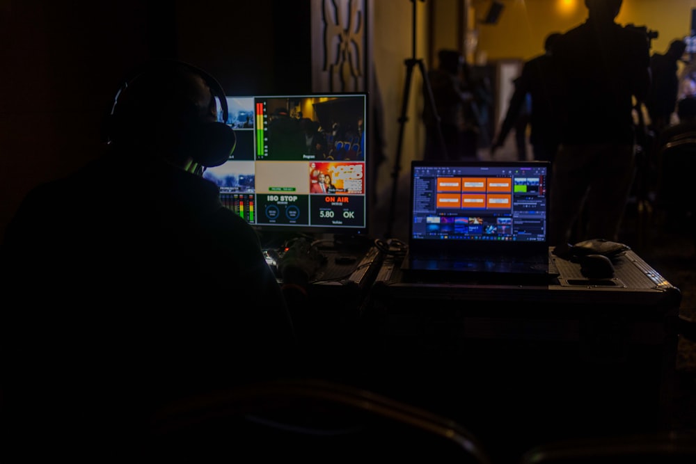 a man sitting in front of a laptop computer