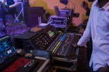 Technicians managing live streaming controls during a mixed conference event.