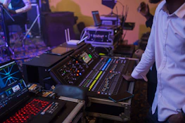 Technician adjusting sound and lighting controls during a wedding celebration.