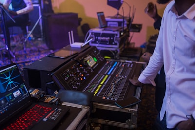 An audio engineer adjusting sound levels during a vibrant live concert.