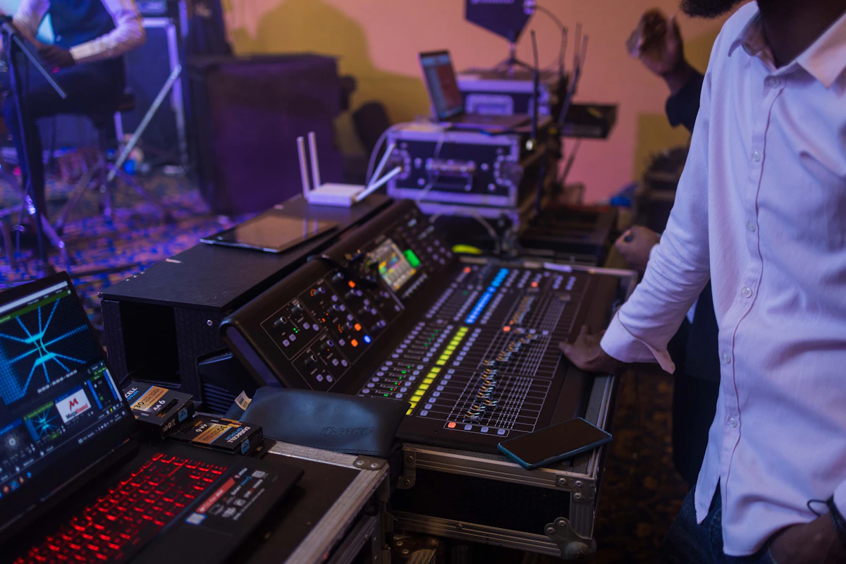 Music producer working at an audio mixing console in a recording studio