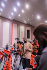 a man standing in front of a camera in a building