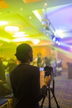 A warm, inviting photo of a professional photographer at work in a corporate event setting.