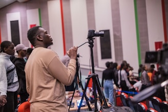 a man standing in front of a microphone in a room