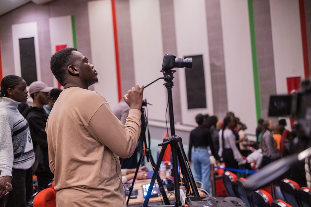 a man standing in front of a microphone in a room