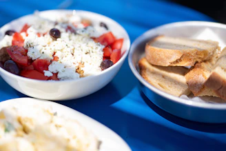 a blue table topped with bowls of food