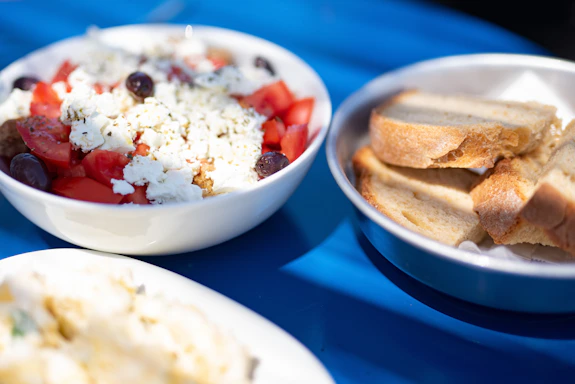 a blue table topped with bowls of food