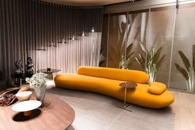 Modern sectional sofa in bright yellow fabric displayed in a stylish room.