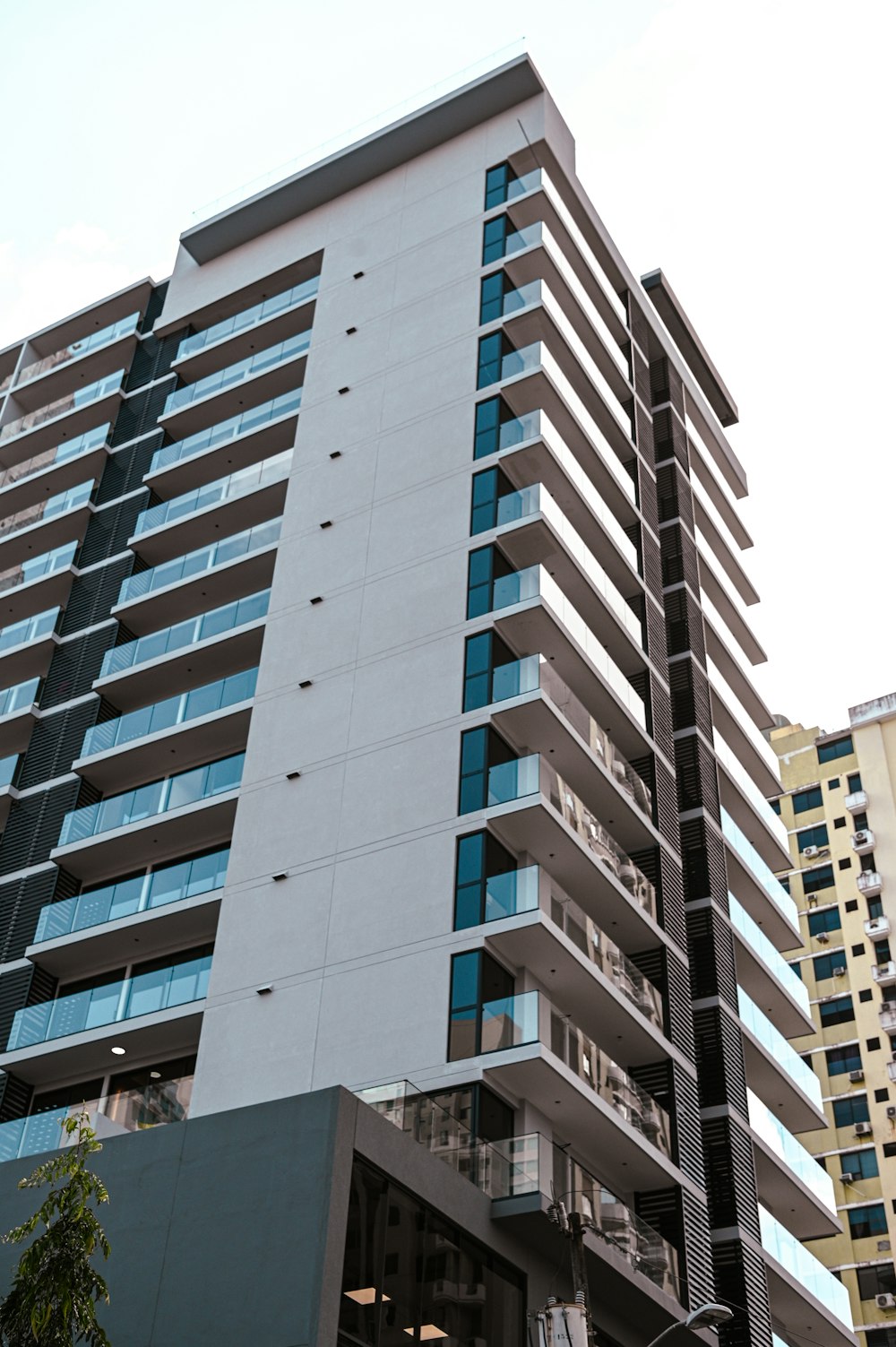 a tall building with many windows next to a street