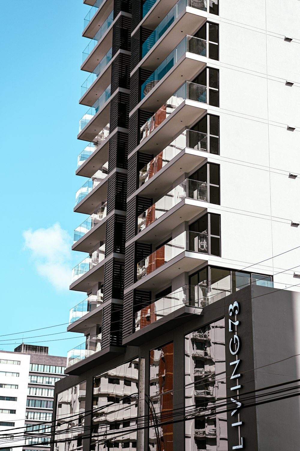 a tall building with balconies on the top of it