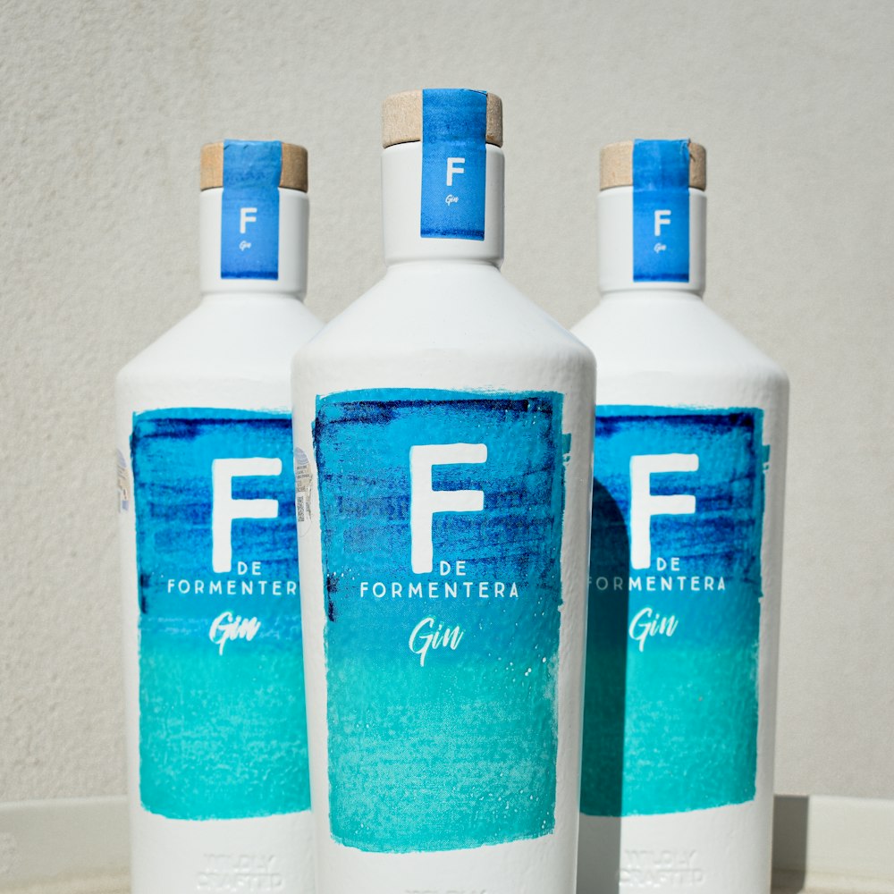three bottles of fff water sitting on a table