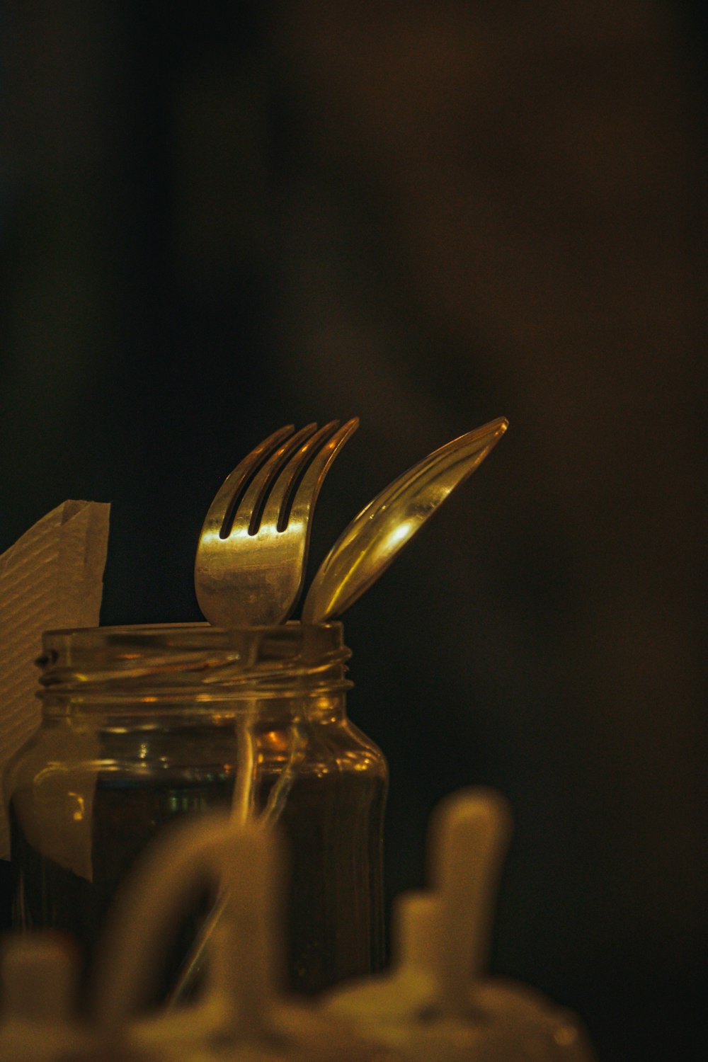 a close up of a fork and a jar of food