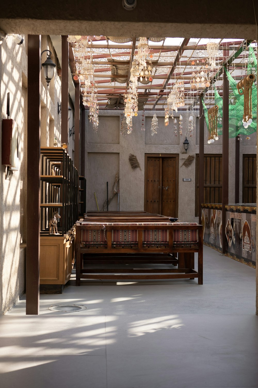 a room with a bench and a chandelier hanging from the ceiling