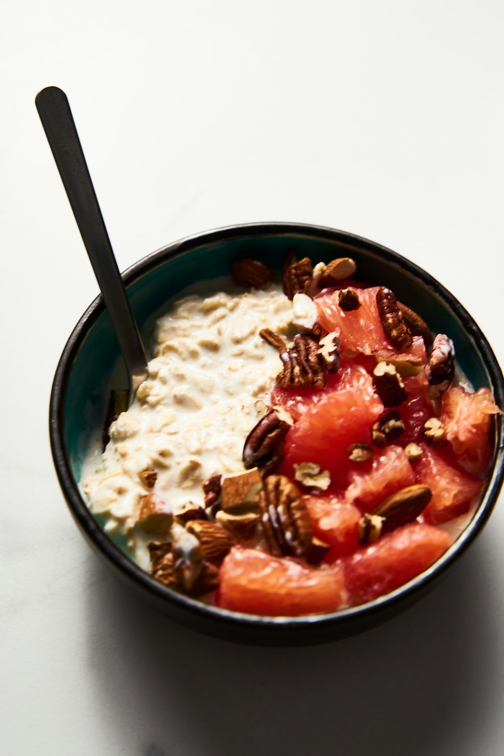 a bowl of oatmeal with fruit and nuts