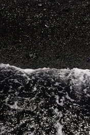 a person riding a surfboard on top of a wave