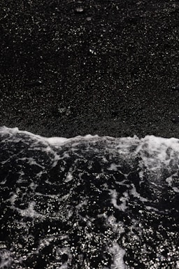 a person riding a surfboard on top of a wave