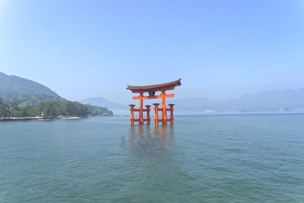 a large body of water with a small structure in the middle of it