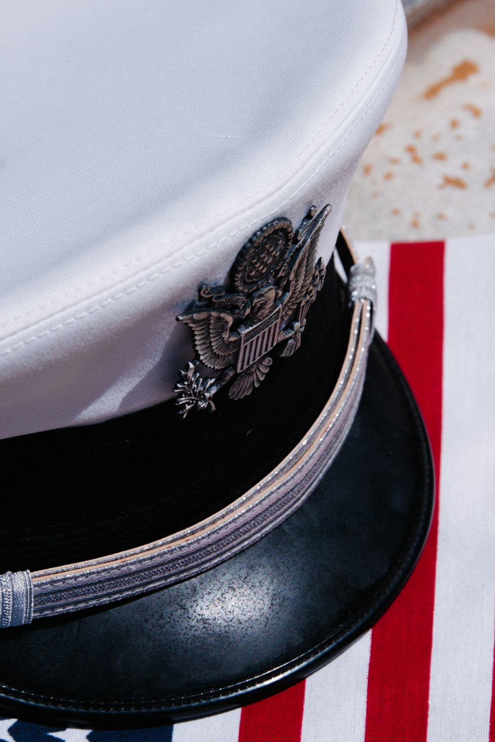 a close up of a hat on top of an american flag