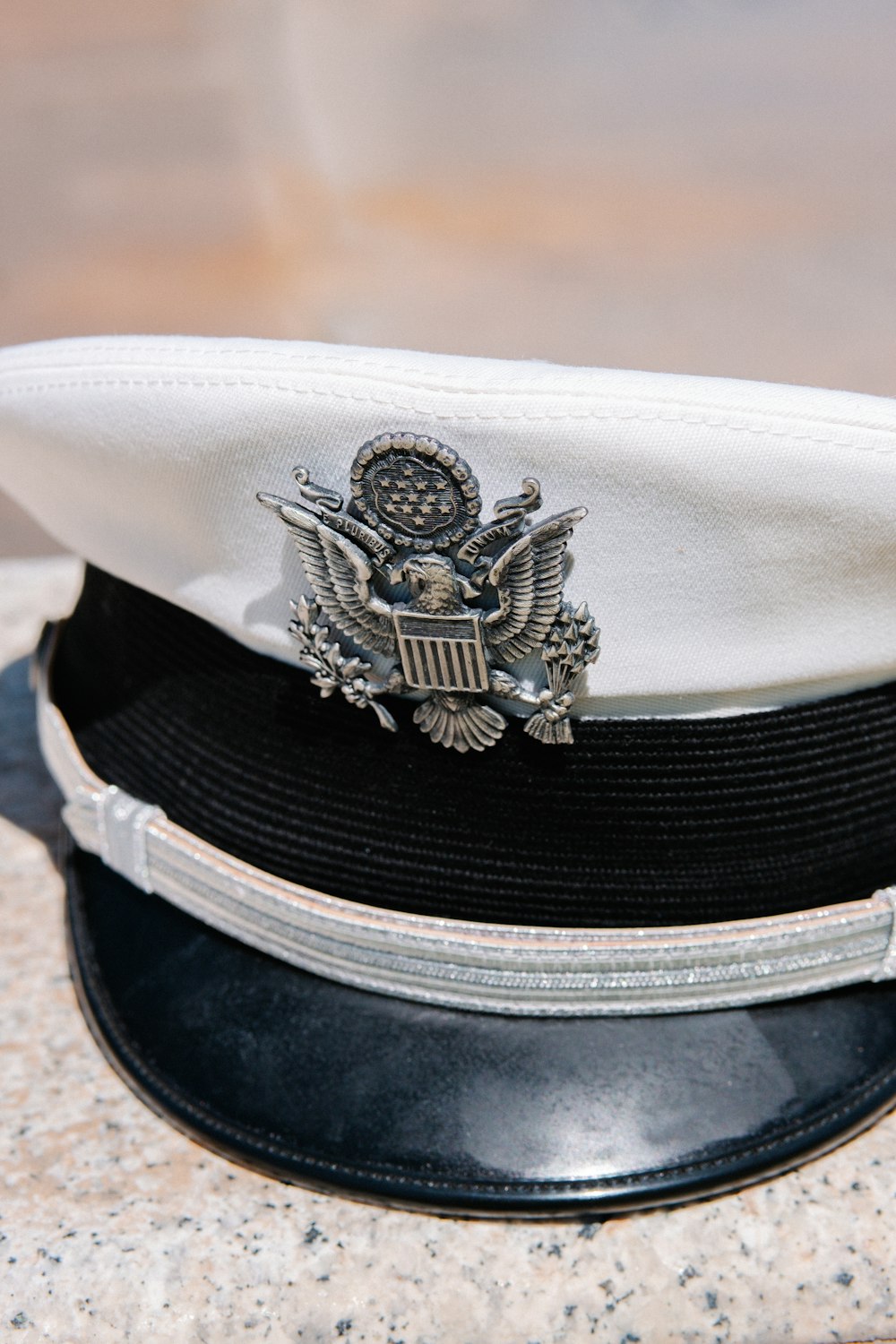 a white hat with a us navy emblem on it