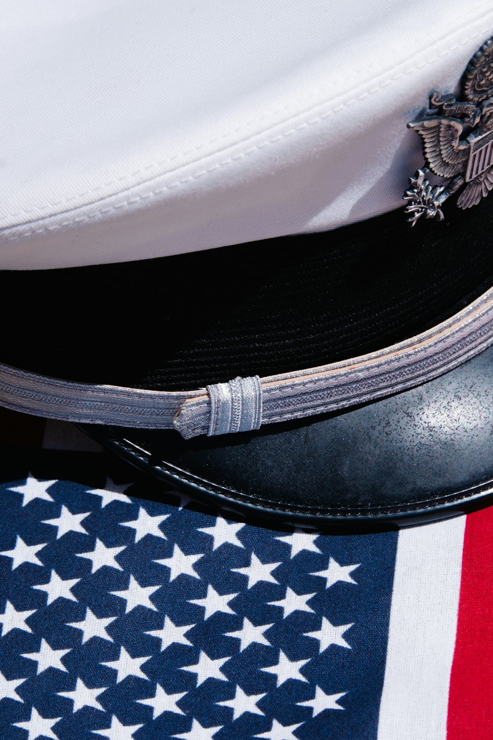 a close up of a hat on top of an american flag