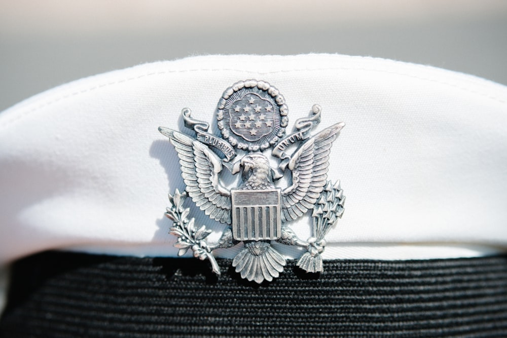 a white hat with an eagle emblem on it
