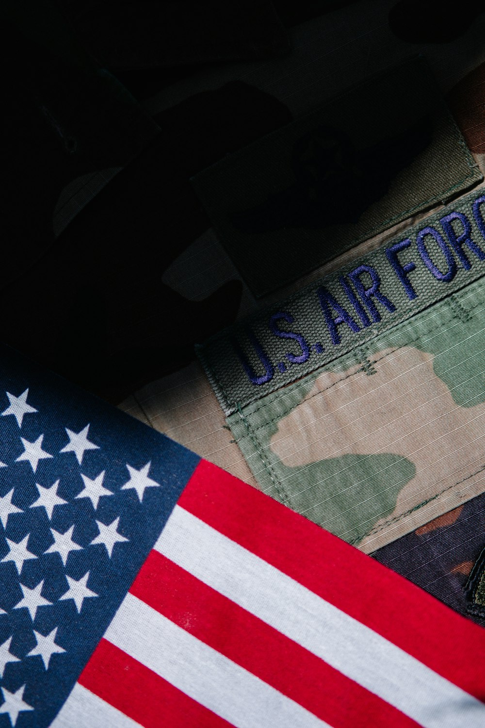 a close up of a us army uniform and an american flag