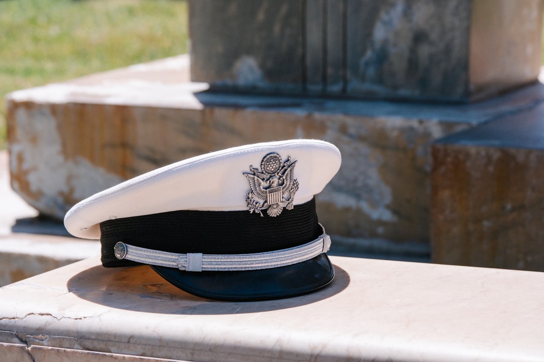 a hat sitting on top of a stone bench,