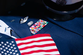 a close up of an american flag on a suit