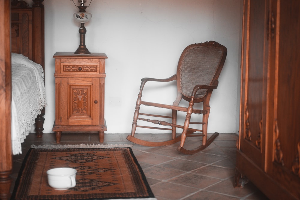 a rocking chair in a room with a rug on the floor