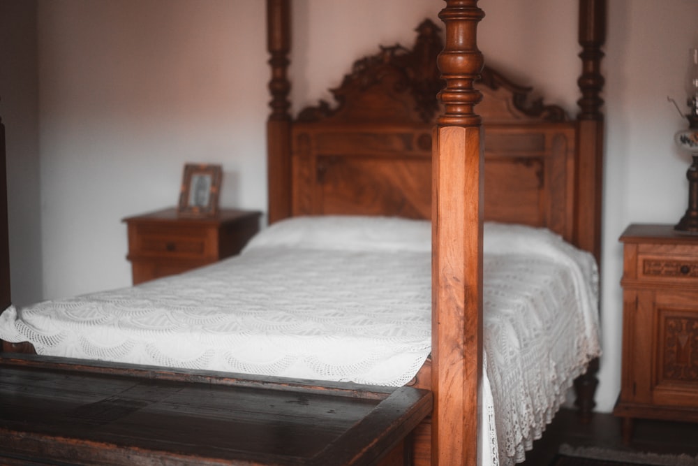 a bed with a wooden headboard and foot board