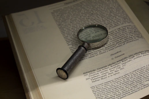 Magnifying glass highlighting misleading energy claims on a document.