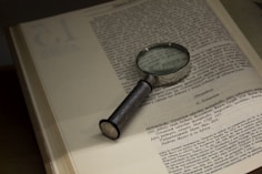 a magnifying glass sitting on top of an open book