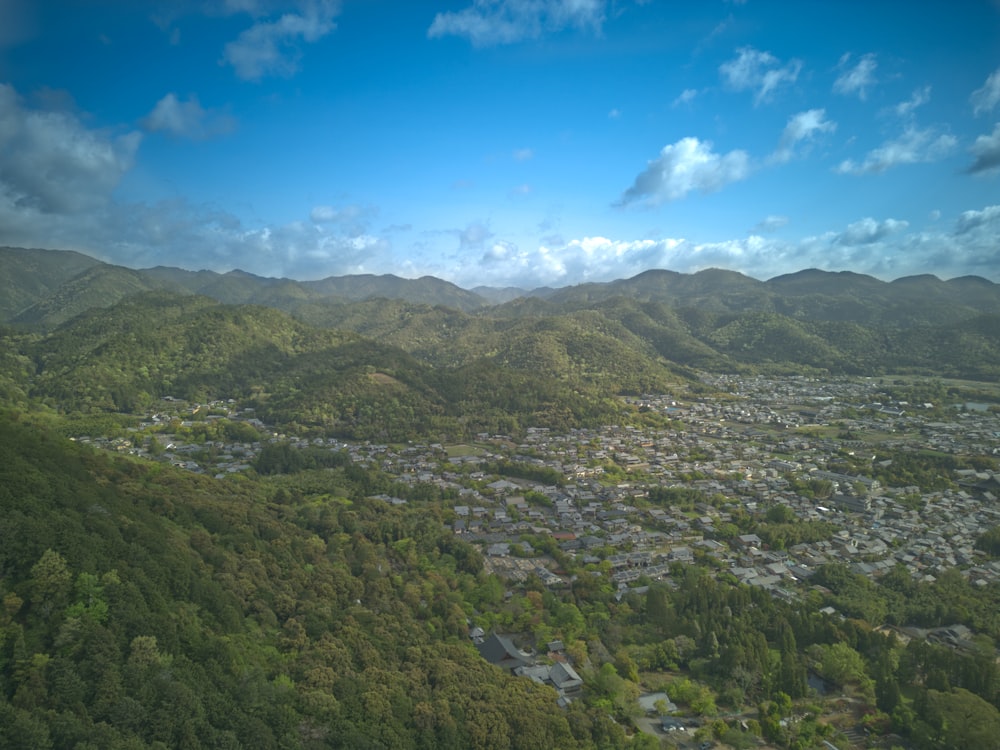 an aerial view of a city surrounded by mountains