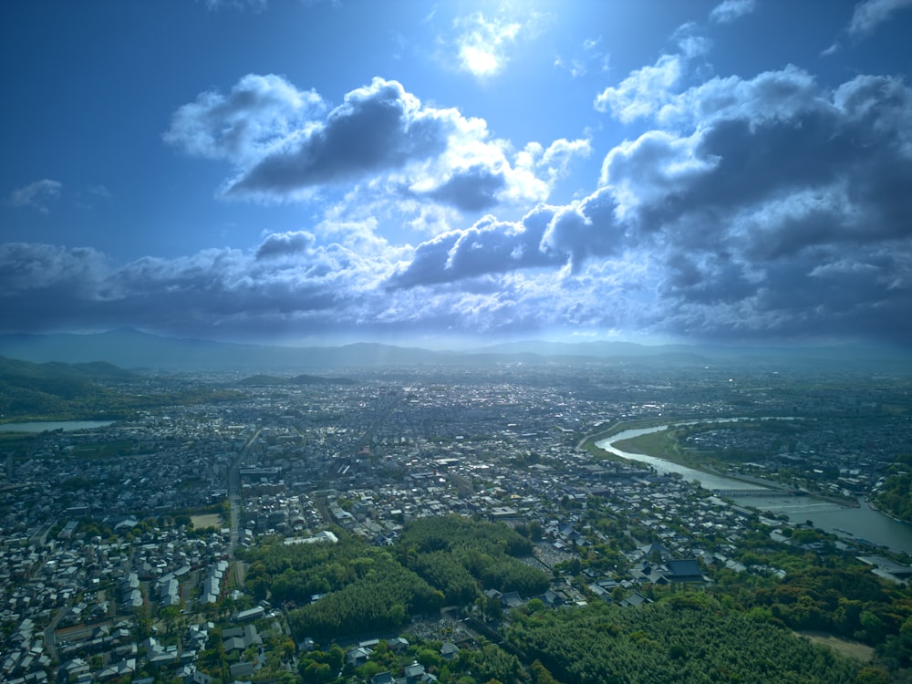 an aerial view of a city under a cloudy sky