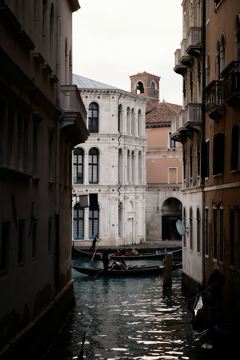a small boat in a narrow canal between two buildings