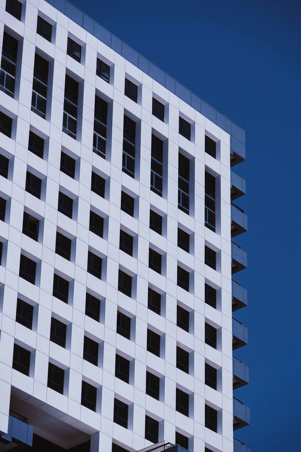 a tall white building with lots of windows