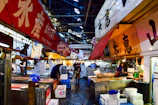 A bustling Japanese fish market showcasing fresh seafood and lively vendors.