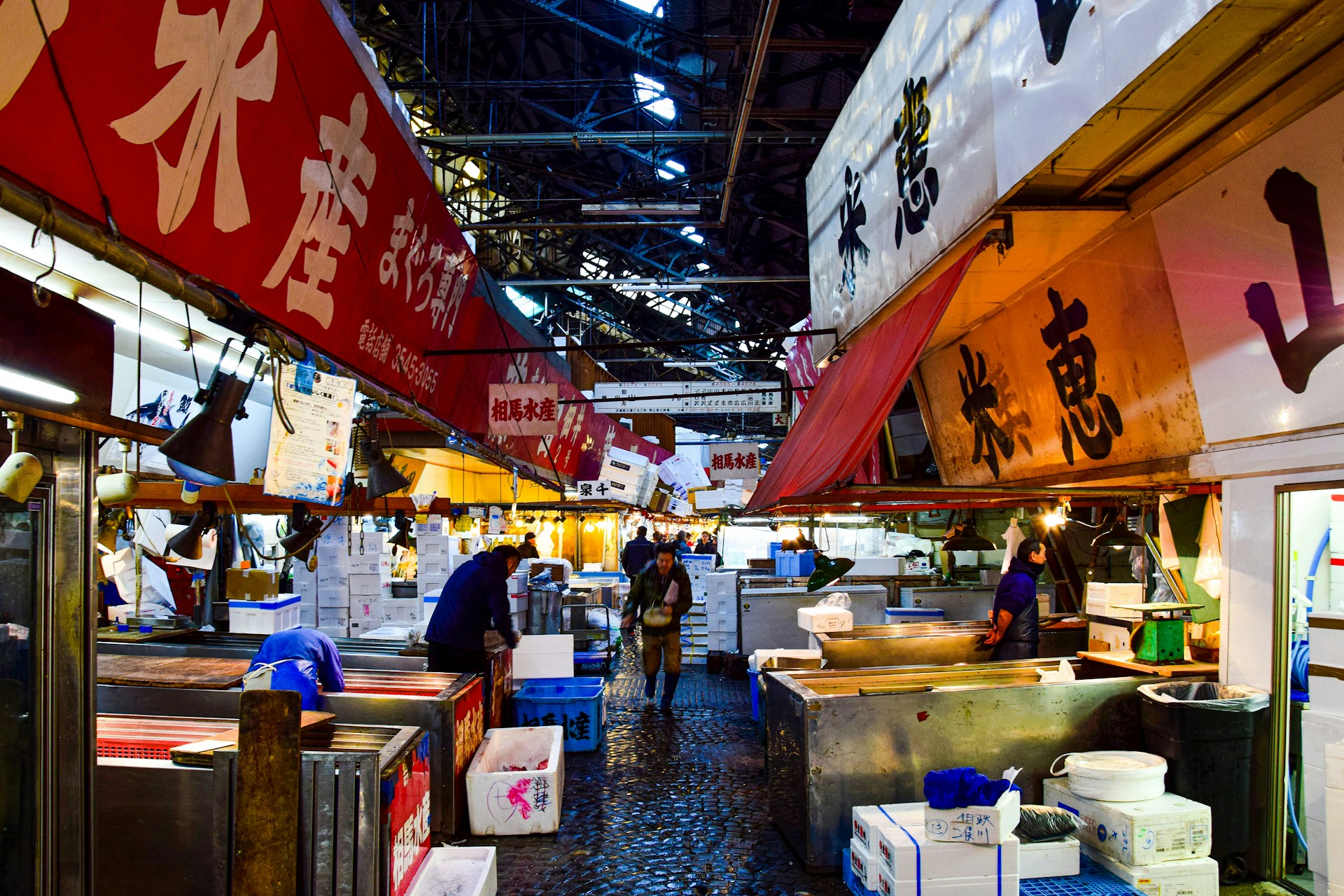 a group of people walking through a market area