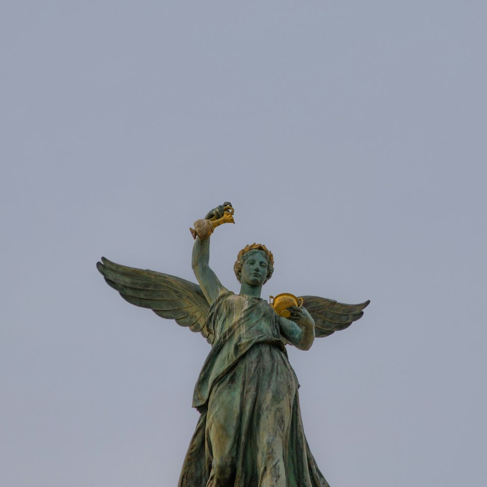 a statue of an angel holding a bird