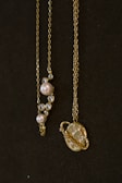 a couple of necklaces sitting on top of a table