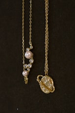 a couple of necklaces sitting on top of a table