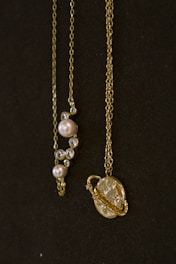 a couple of necklaces sitting on top of a table
