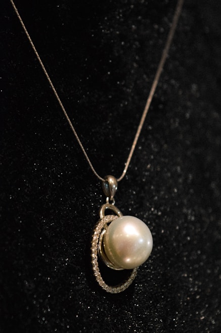 An elegant pendant hanging against a soft background.