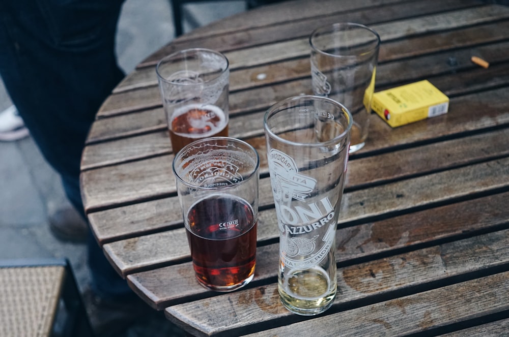 a group of glasses sitting on top of a wooden table