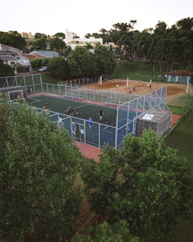a group of people playing tennis on a tennis court