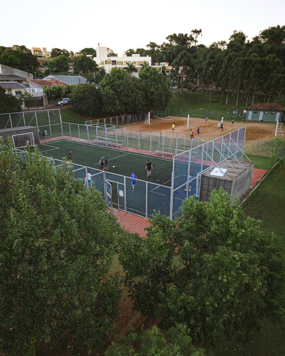 a group of people playing tennis on a tennis court