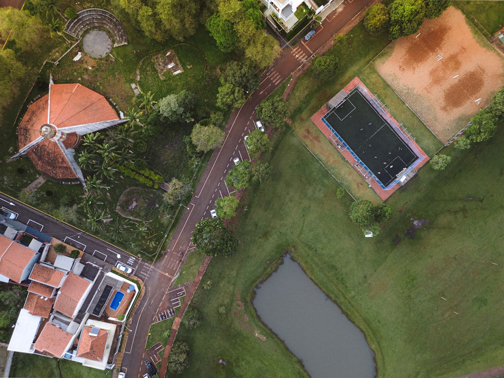 an aerial view of a tennis court in a park